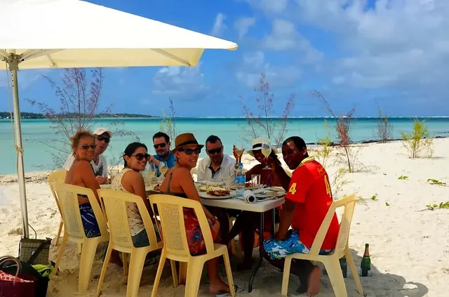 Guests having lunch at a table on the beach