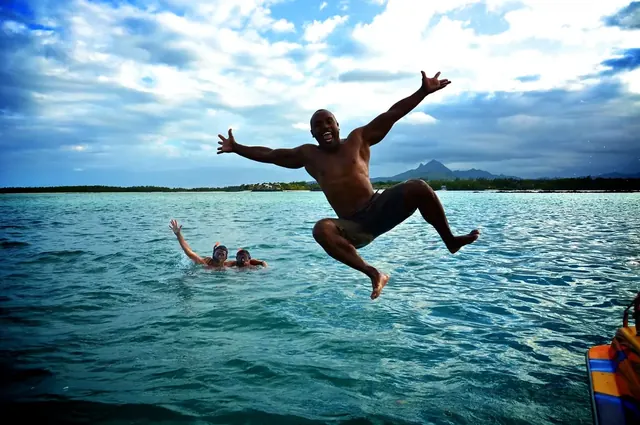 A guest jumping into the lagoon from the boat